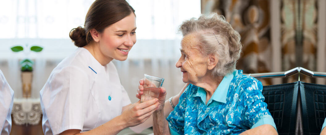 Senior woman with her caregiver at home